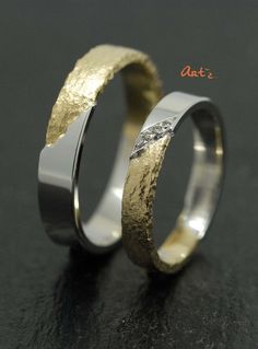 two wedding bands with gold and silver inlays on each side, one is made out of metal