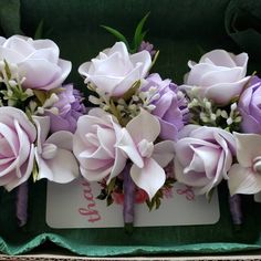 purple and white flowers are in a green box with tags on the side that says do not touch