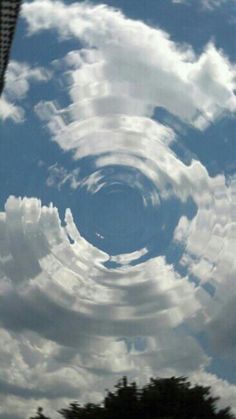 the sky is filled with white clouds and some blue skies are in the foreground