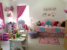 a child's bedroom decorated in pink and blue