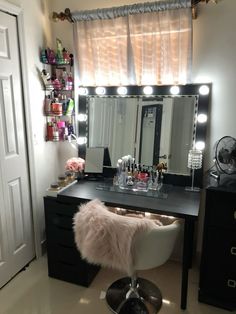 a vanity with lights on it and a fur stool in front of the mirror that is lit up