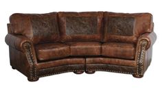 a brown leather couch sitting on top of a white floor