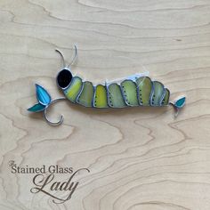 the stained glass lady insect is sitting on top of a wooden surface with its eyes closed