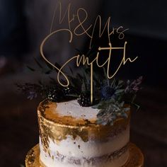 a white and gold wedding cake with the words ms & m's smith on top