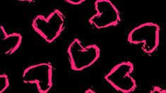 pink hearts drawn on black background