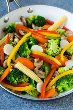 a white bowl filled with vegetables and olives