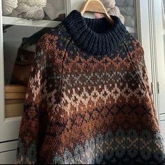 a sweater hanging on a rack in front of a door