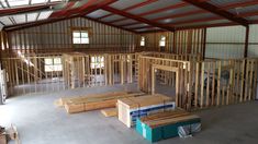 the inside of a building that is being built with metal bars and wooden beams in place