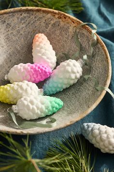 some pine cones are in a bowl on a table