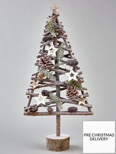 a small wooden christmas tree with pine cones and starfishs on it's branches