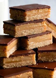 several pieces of chocolate and peanut butter bars stacked on top of each other