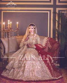 a woman in a wedding dress sitting on a couch