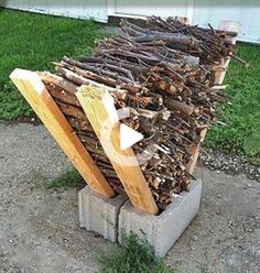 a pile of wood sitting on top of a cement block