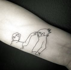 a person with a tattoo on their arm that has a drawing of two people holding hands