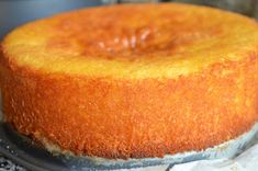 a yellow cake sitting on top of a metal pan