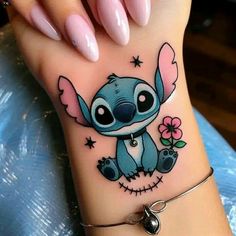 a woman's foot with a tattoo on it that has a cartoon character in the middle