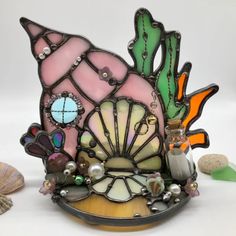 there is a glass sculpture with shells on it