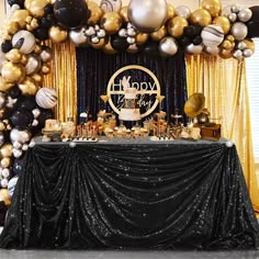 a black and gold birthday party with balloons, streamers, cake and dessert table