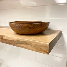 a wooden bowl sitting on top of a shelf