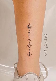 a woman's foot with an anchor tattoo on her left leg and the word love written