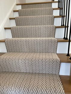 the carpeted stairs are lined with black and white herringbones