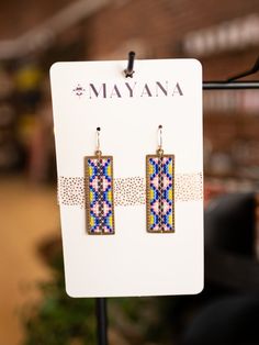 a pair of earrings on display in a store