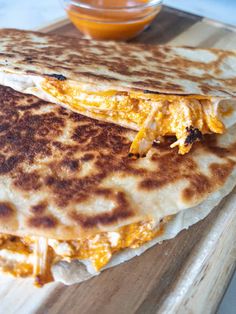 two quesadillas sitting on top of a cutting board