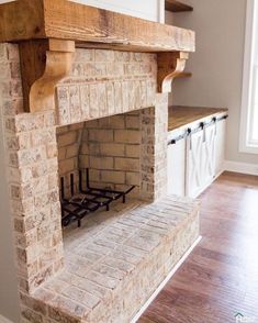 a brick fireplace in the middle of a kitchen