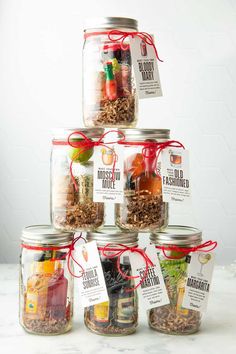 a stack of jars filled with different types of food