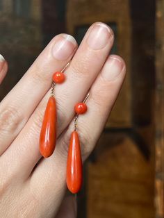 An outstanding pair of Victorian coral torpedo drops with sumptuous button tops. I have handled many pairs of Victorian coral earrings, but none with the sharp, excellent simplicity of this pair. If you've enjoyed a look at our Georgian Chalcedony torpedo earrings, what is so lovely about these Coral drops is that they detail the progression of the classic 19th century torpedo shape; whereas the chalcedony pair from the 1820's shows a dormeuse top, and conical fitted hold for the drops to attach Coral Drop Earrings, Historical Jewellery, Jewelry Turquoise, Coral Earrings, Coral Jewelry, Coral Necklace, Victorian Era, Turquoise Jewelry, Luxury Jewelry