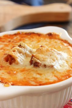 a casserole dish with cheese and meat in it