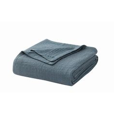 a blue blanket folded on top of a white background