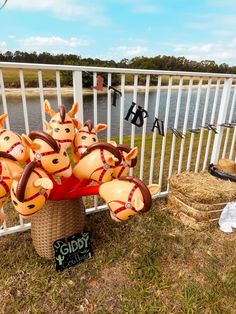 a basket filled with lots of fake giraffes sitting on top of a grass covered field