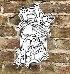 a sticker on the side of a brick wall with a skull and flowers in it