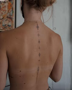 a woman with a tattoo on her back