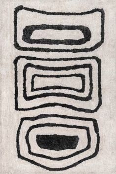 a black and white rug with lines drawn on the ground in different directions, including two circles