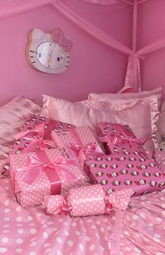 a hello kitty themed bedroom with pink and white polka dot bedspread, twin size pillowcases and pillows