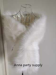 a white fur coat hanging on a clothes hanger with the words anna party supply above it