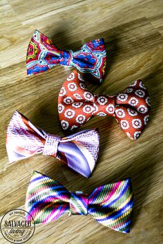 three different types of bow ties on a wooden surface