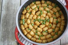 a pan filled with tater tots on top of a wooden table