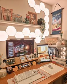 a computer desk with two monitors, keyboard and mouse on it in front of a light fixture