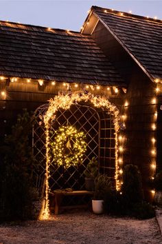 a lighted archway with a wreath on it and lights hanging from the side of it