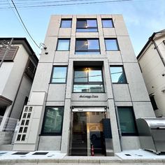 an apartment building with many windows and doors