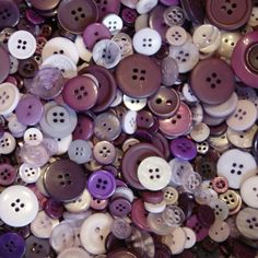 a pile of purple and white buttons sitting on top of each other