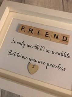 a wooden scrabble frame with words and a heart on it that says, friend