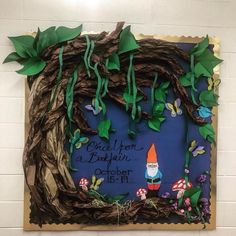 a bulletin board is decorated with leaves and gnomes