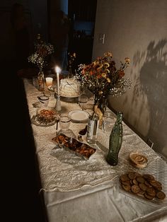 a table topped with lots of food and candles