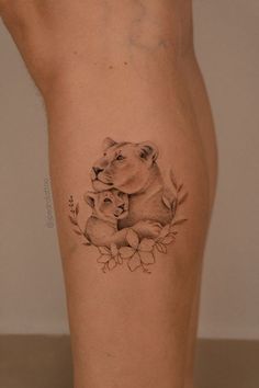 a woman's leg with a tattoo of a dog and cat on it,