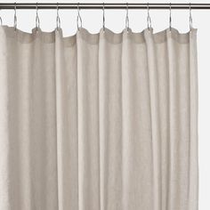 a white curtain hanging from a metal rod