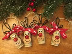 three christmas bells hanging from the side of a tree with red bows and reindeer noses on them